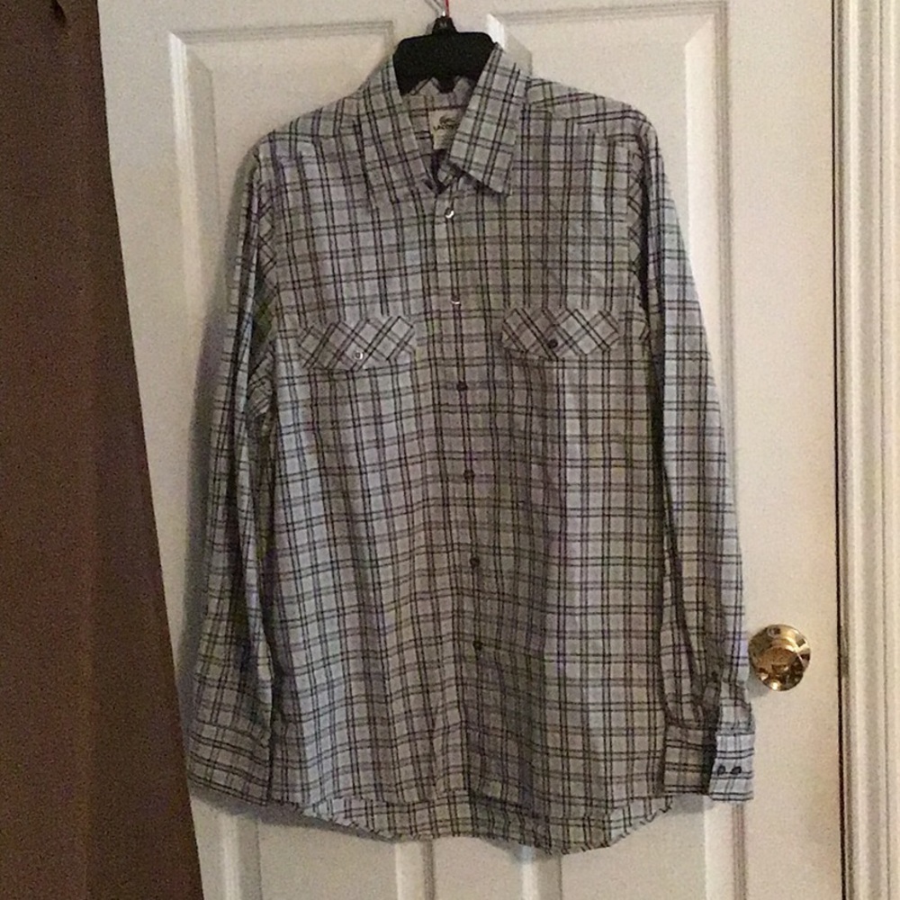 Long sleeves dress shirt by Lacoste with 2 front pockets.